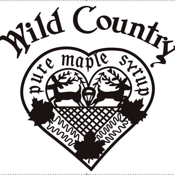 A black and white logo with the text "Wild Country" at the top. Below it, a heart shape contains two deer, maple leaves, and a textured pattern. The text "pure maple syrup" is written along the curve of the heart's interior, evoking a cozy atmosphere reminiscent of enjoying coffee in Duluth.
