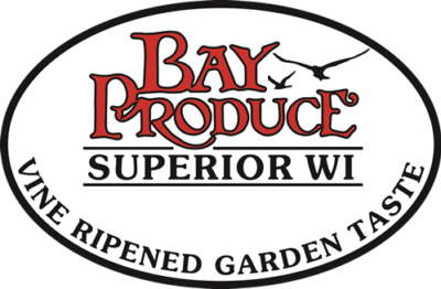 Bay Produce logo featuring a white oval background with a black border. "Bay Produce" in large red text with two flying birds, and "Superior WI" in smaller black text below. The bottom edge reads "Vine Ripened Garden Taste" in black text, perfect for pairing with the best coffee in Duluth.