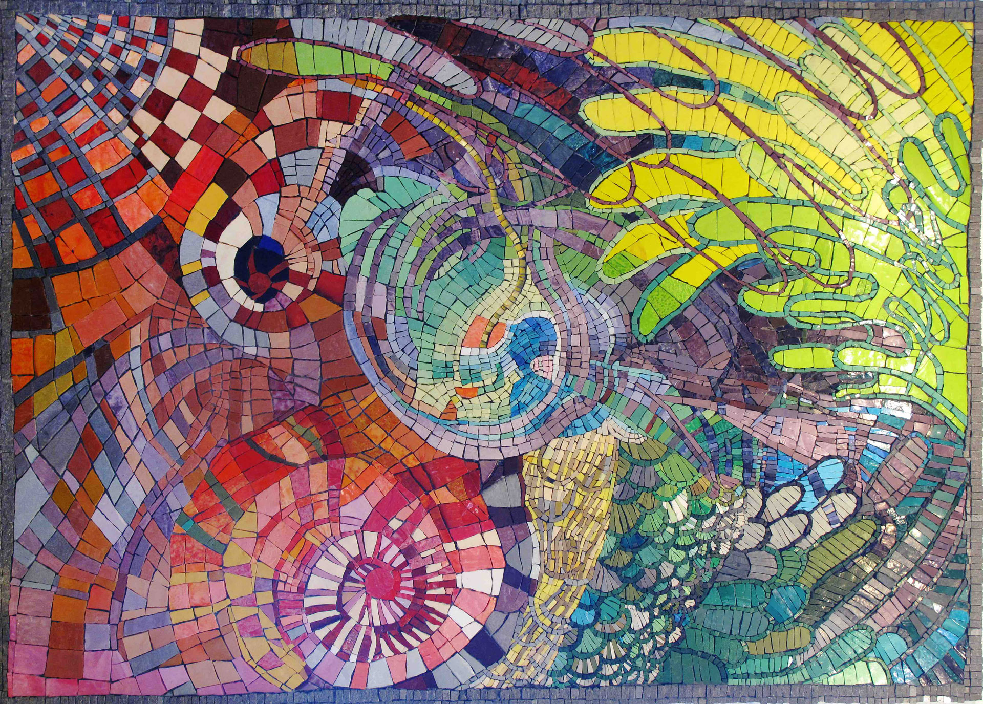 A colorful mosaic composed of small tiles arranged in intricate patterns and swirls. This piece of local art features a mix of geometric shapes, including circles and squares, with a vibrant palette of reds, blues, greens, yellows, and purples, creating a dynamic and lively image.