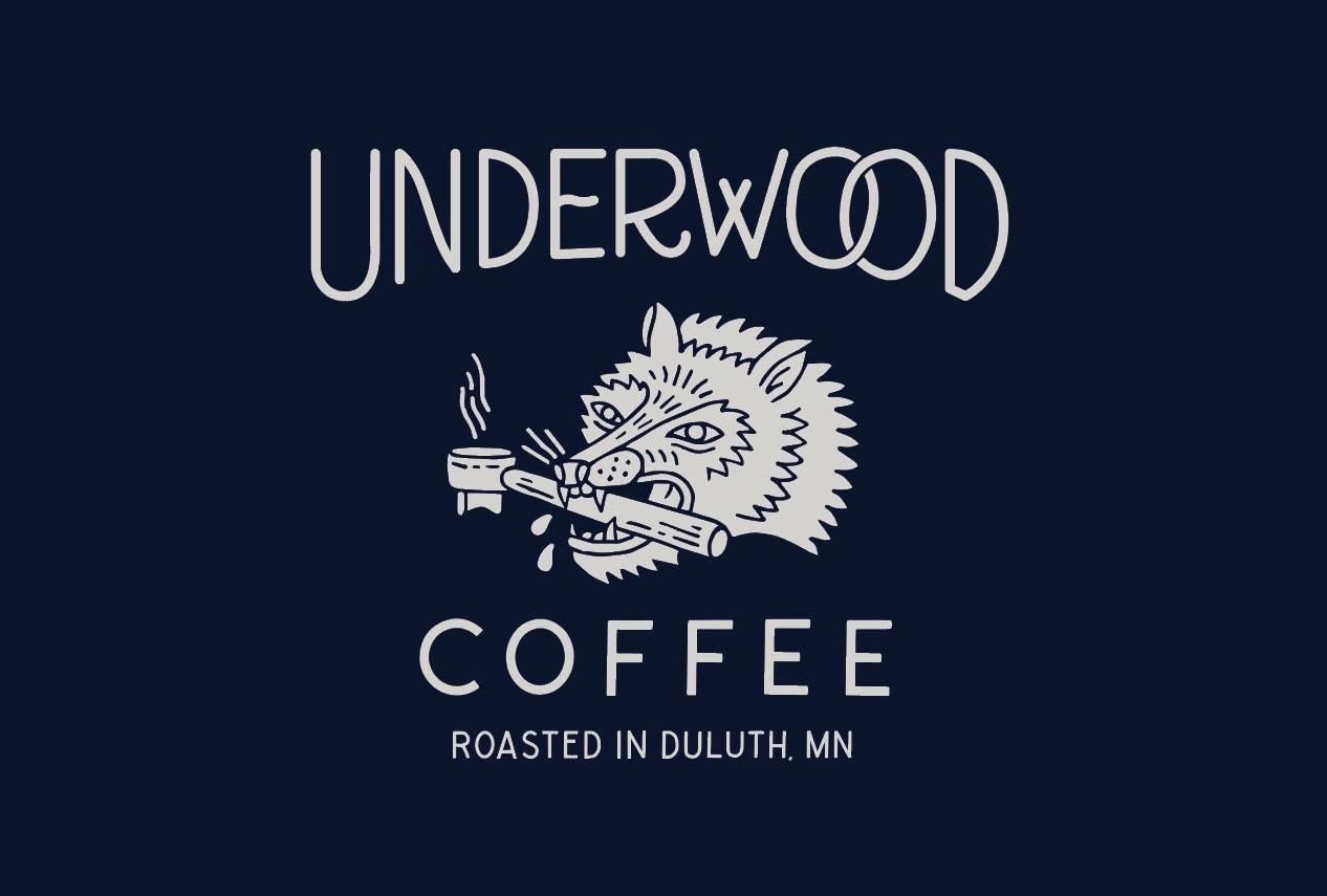 Logo for Underwood Coffee featuring a stylized drawing of a wild boar holding a coffee cup in its mouth, with steam rising from the cup. The text reads "UNDERWOOD COFFEE - COFFEE IN DULUTH ROASTED IN MN" on a dark background.