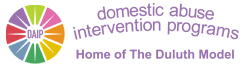 A logo with a colorful circular icon on the left and purple text to the right. The icon has segments in various colors with "DAIP" at the center. The text reads "domestic abuse intervention programs" with "Home of The Duluth Model" below it.