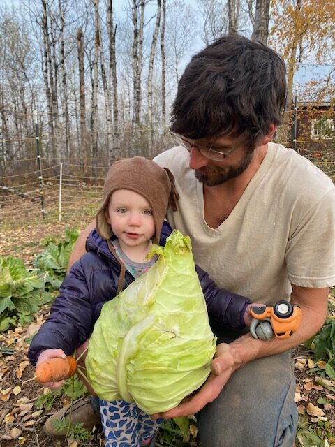 Ben Cogger, his child, and a large cabbage