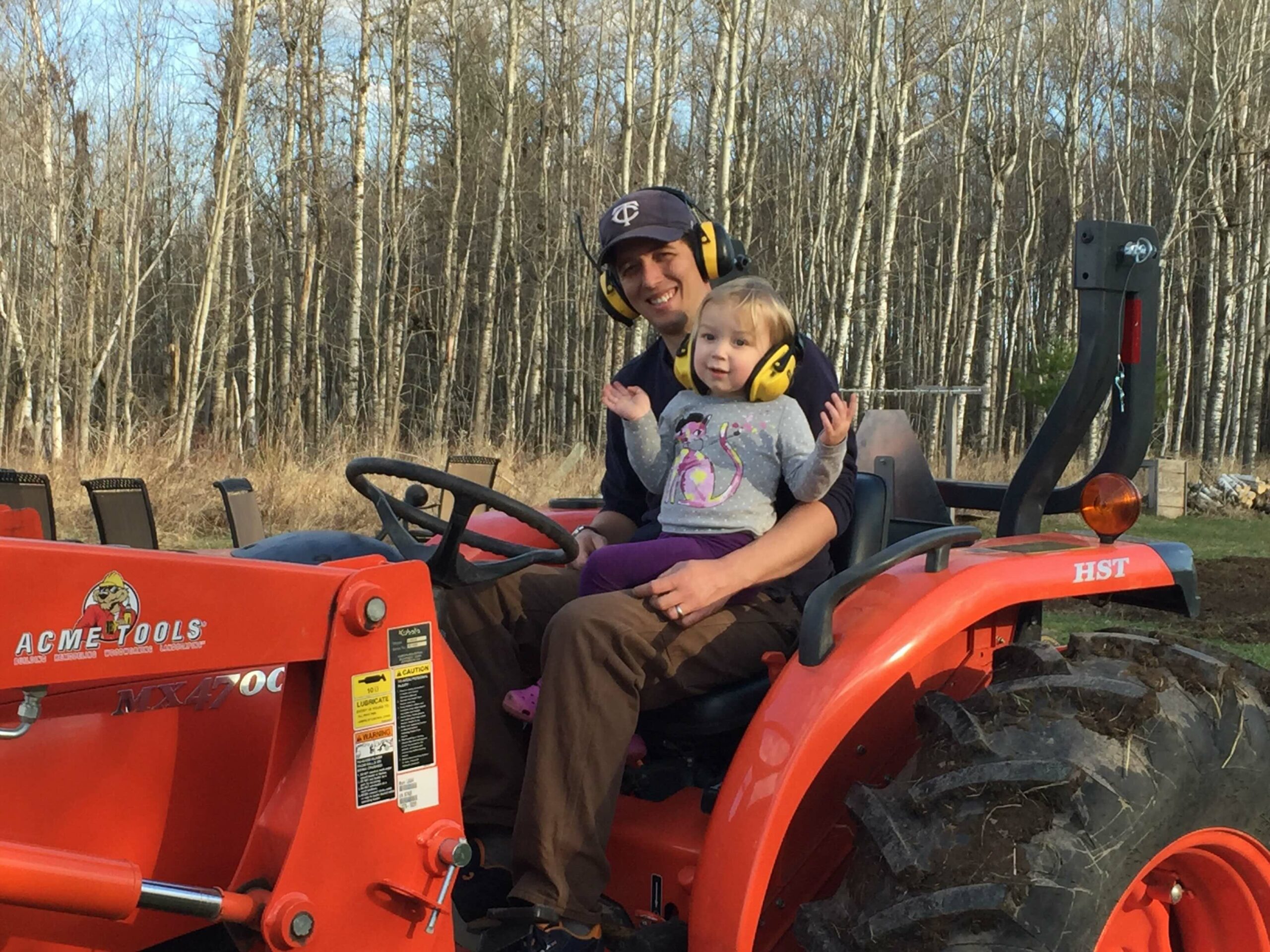 Adam Kemp and his daughter on a tractor