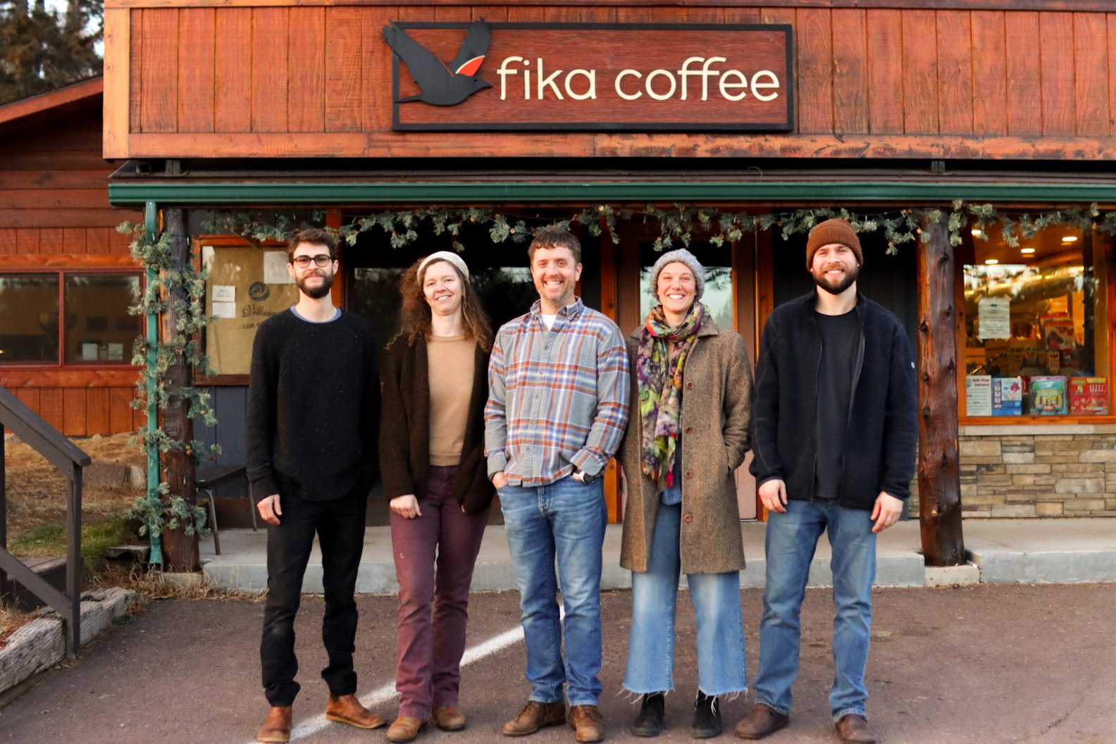 Group of people standing in front of Fika Coffee shop.