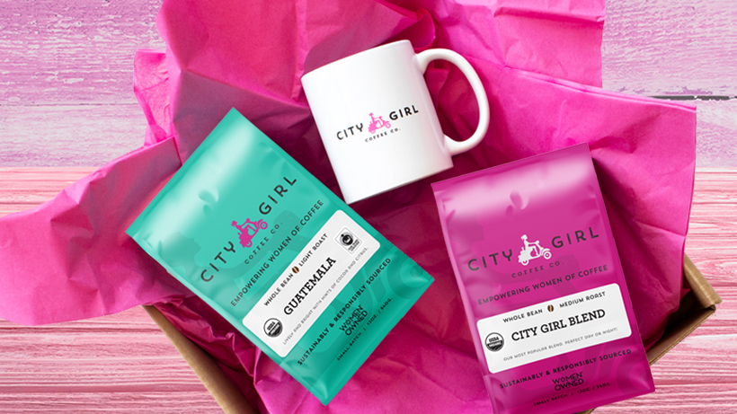 City Girl Coffee bags, Guatemala and City Girl Blend, and mug with logo in a box with pink tissue paper.