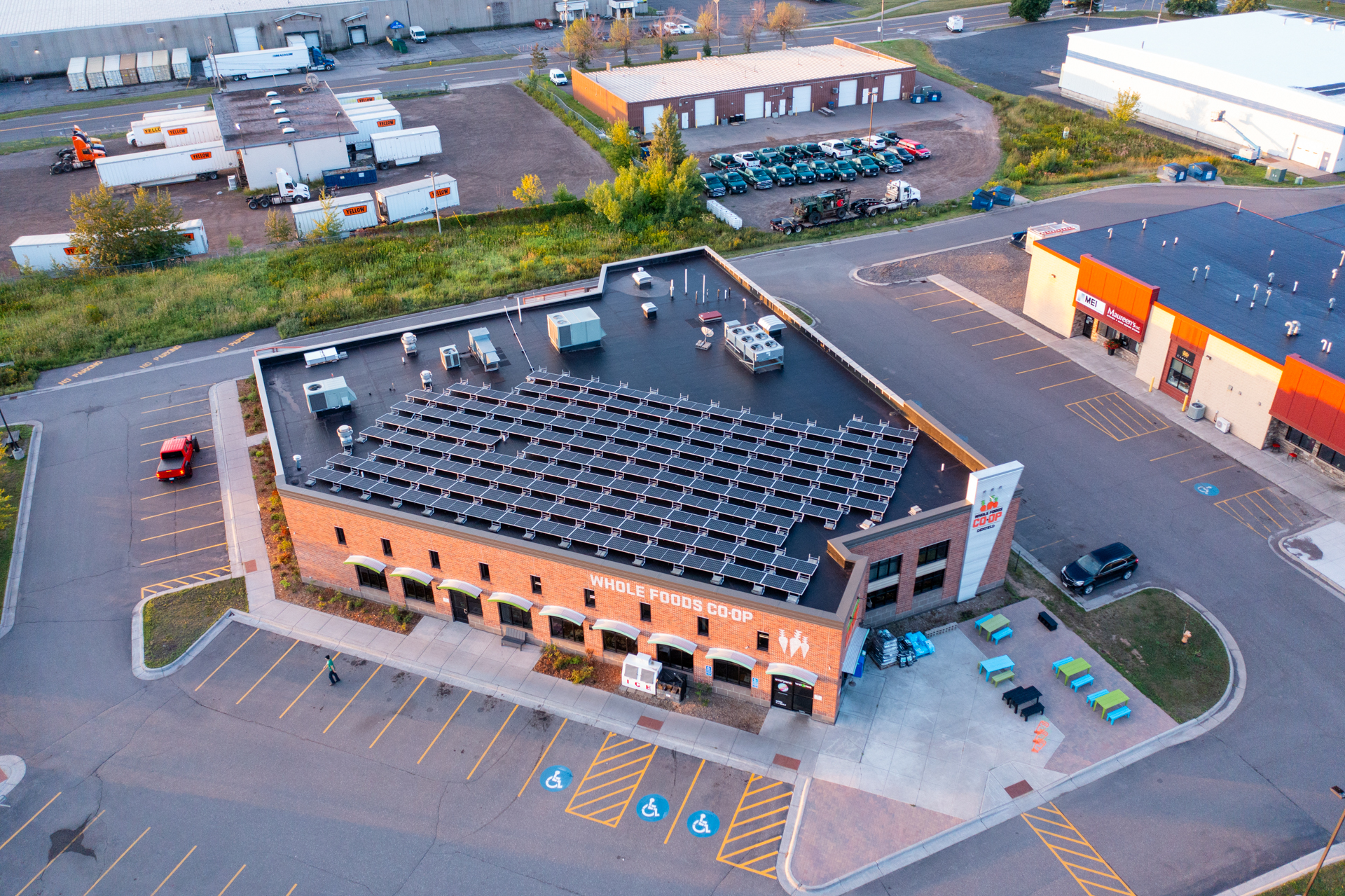 Aerial view the Whole Foods Co-op Denfeld store. An array of solar panels can be seen on the rooftop.