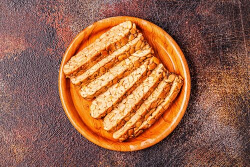 Sliced fresh raw tempeh, traditional Indonesian food made from soya bean