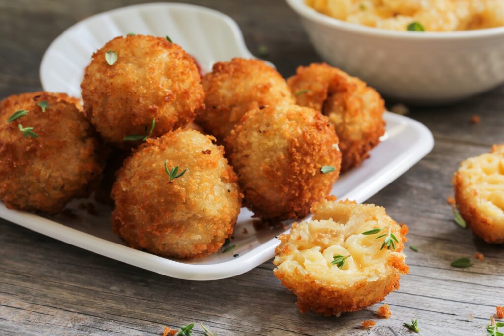 Fried Mac and Cheese balls served with ketch up, selective focus