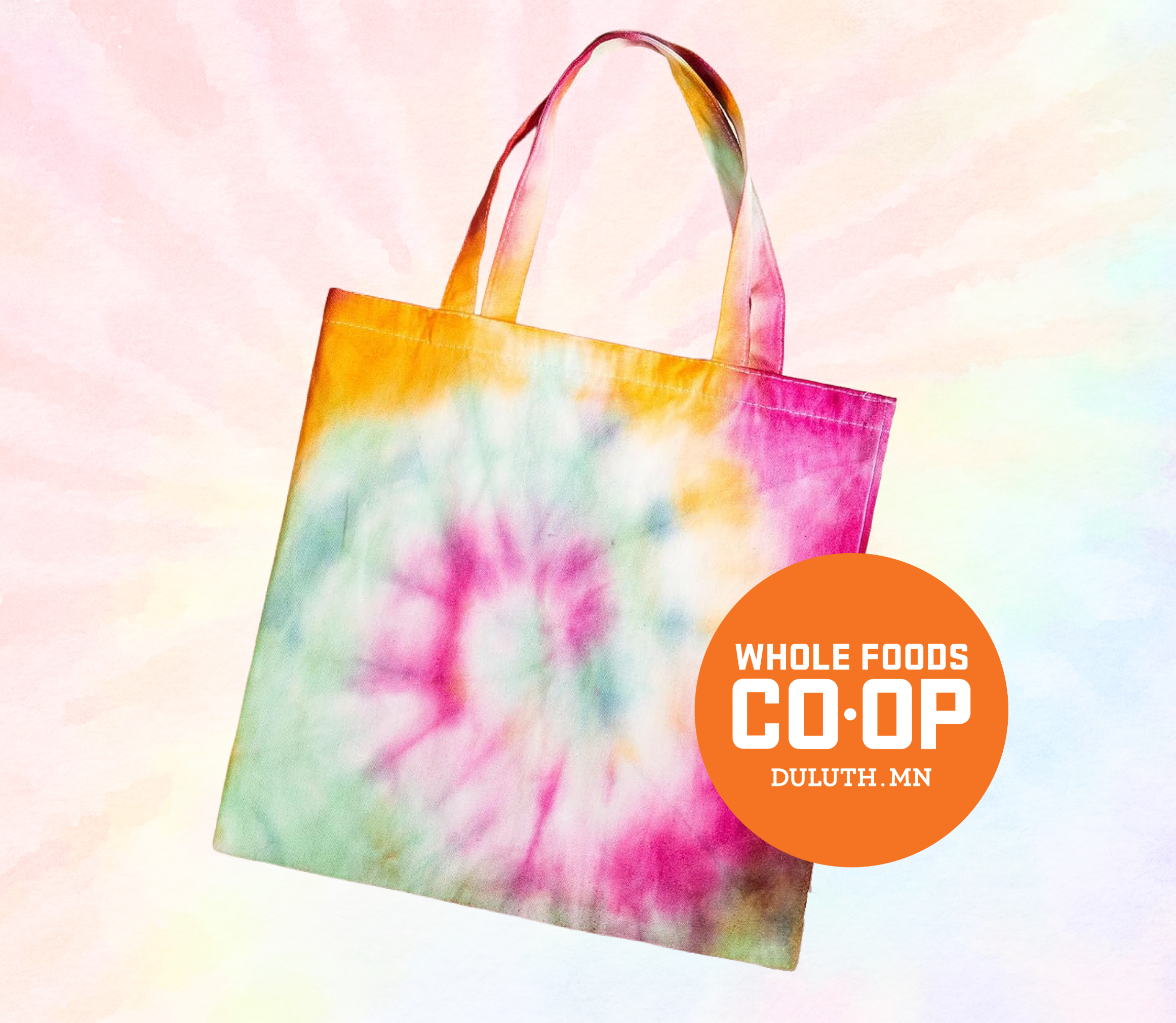 A tie dye tote bag on a light tie dye background.